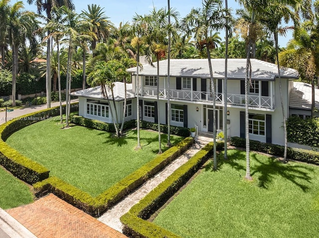 2500 Lake Ave, Miami Beach, FL 33140 - back of property with a balcony, a yard, and stucco siding