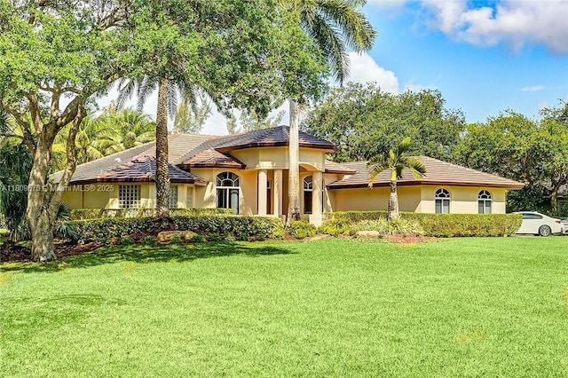 6807 NW 66th Way, Parkland, FL 33067 - mediterranean / spanish-style home featuring a front yard and stucco siding