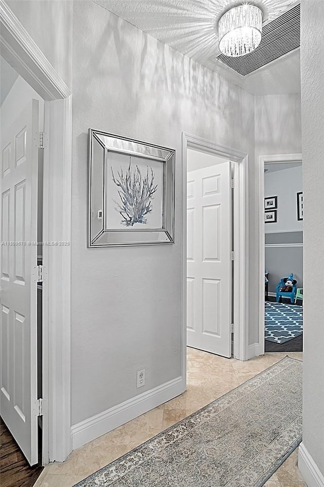 6807 NW 66th Way, Parkland, FL 33067 - hall featuring a chandelier and baseboards