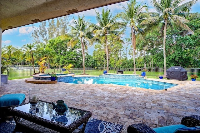6807 NW 66th Way, Parkland, FL 33067 - view of pool featuring area for grilling, a fenced backyard, a patio area, and a pool with connected hot tub