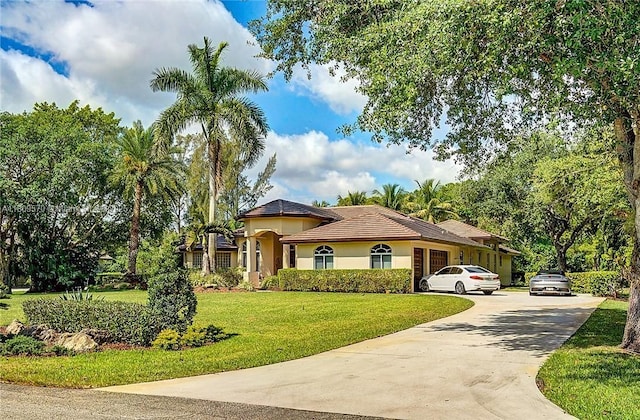 6807 NW 66th Way, Parkland, FL 33067 - mediterranean / spanish home with concrete driveway, a front yard, and stucco siding