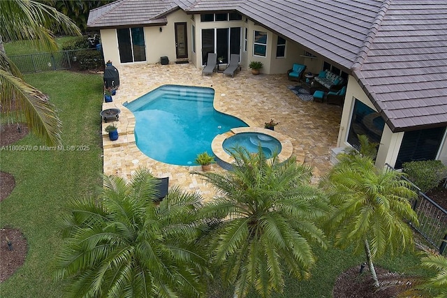 6807 NW 66th Way, Parkland, FL 33067 - view of pool with a patio area, a fenced backyard, a pool with connected hot tub, and an outdoor fire pit