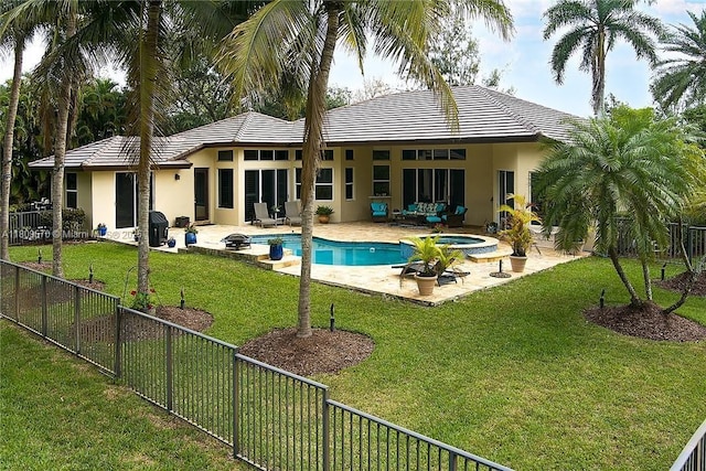 6807 NW 66th Way, Parkland, FL 33067 - rear view of property with a fenced backyard, stucco siding, a patio, a pool with connected hot tub, and a tiled roof