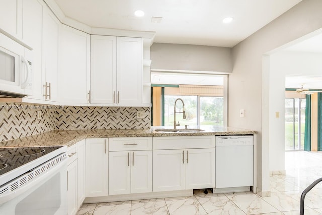 16985 SW 113th Ct Unit 31541E, Miami, FL 33157 - kitchen featuring white appliances, light marble finish flooring, white cabinets, backsplash, and light stone counters
