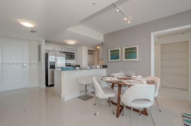 1861 NW S River Dr Unit 807, Miami, FL 33125 - dining area with light tile patterned floors and rail lighting