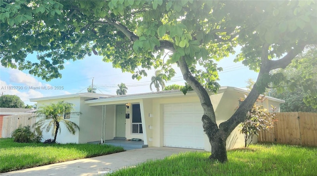 826 N 32nd Ct, Hollywood, FL 33021 - view of front facade with an attached garage, stucco siding, and concrete driveway