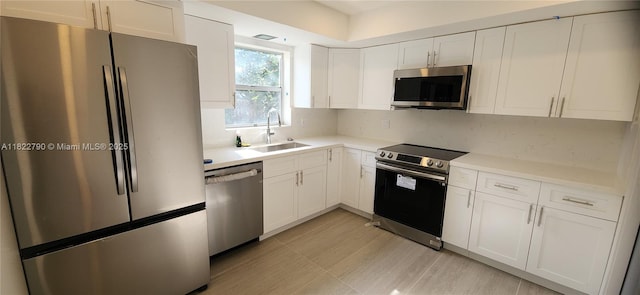 826 N 32nd Ct, Hollywood, FL 33021 - kitchen featuring stainless steel appliances, light countertops, white cabinets, and decorative backsplash