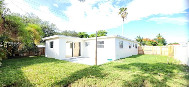 826 N 32nd Ct, Hollywood, FL 33021 - rear view of house featuring stucco siding, a fenced backyard, and a patio area