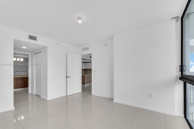 5252 NW 85th Ave Unit 1505, Doral, FL 33166 - empty room featuring healthy amount of natural light and light tile patterned flooring