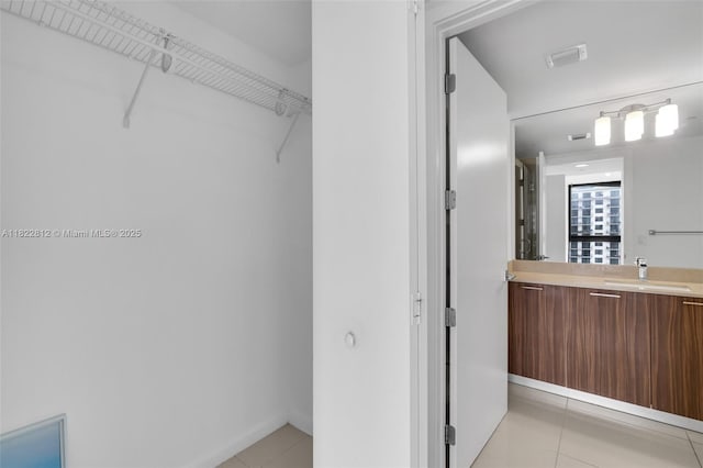5252 NW 85th Ave Unit 1505, Doral, FL 33166 - walk in closet featuring light tile patterned floors and a sink