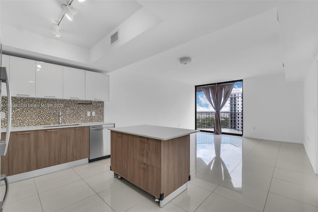 5252 NW 85th Ave Unit 1505, Doral, FL 33166 - kitchen featuring dishwasher, modern cabinets, decorative backsplash, white cabinetry, and light countertops