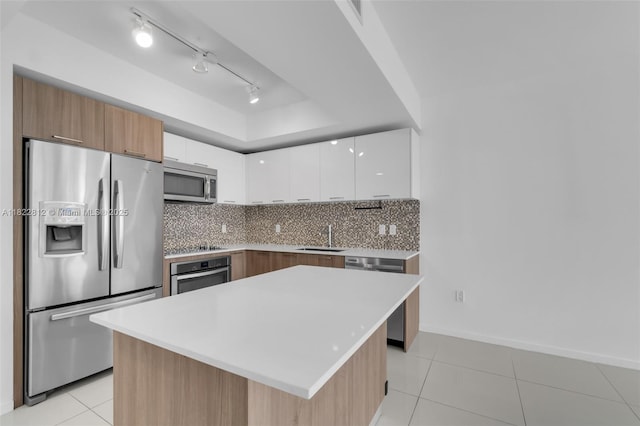 5252 NW 85th Ave Unit 1505, Doral, FL 33166 - kitchen with appliances with stainless steel finishes, modern cabinets, white cabinetry, decorative backsplash, and light tile patterned floors