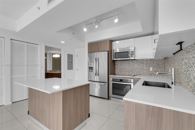 5252 NW 85th Ave Unit 1505, Doral, FL 33166 - kitchen with appliances with stainless steel finishes, modern cabinets, light tile patterned floors, light countertops, and backsplash