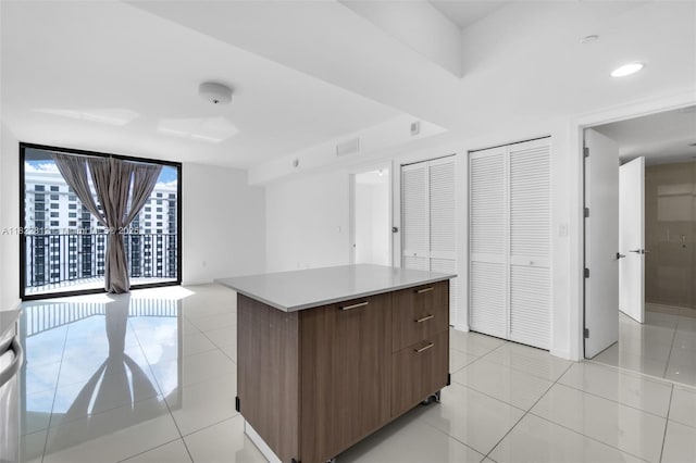 5252 NW 85th Ave Unit 1505, Doral, FL 33166 - kitchen with modern cabinets, a center island, light tile patterned floors, light countertops, and open floor plan