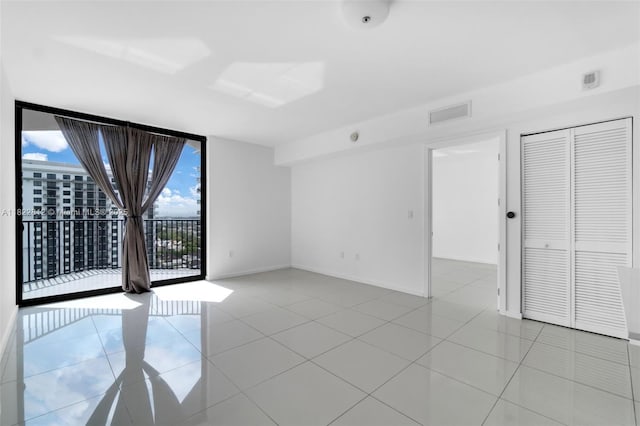 5252 NW 85th Ave Unit 1505, Doral, FL 33166 - unfurnished room featuring a wall of windows and light tile patterned floors