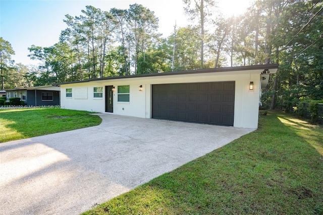 3313 N Ridge Rd, Tallahassee, FL 32305 - single story home with concrete driveway, a front lawn, and an attached garage