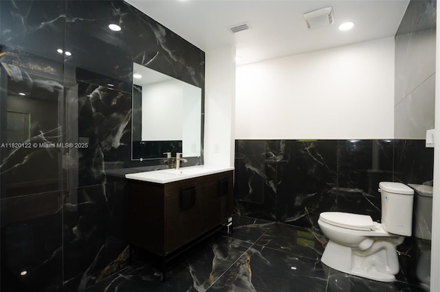 3313 N Ridge Rd, Tallahassee, FL 32305 - full bath featuring marble tiled flooring, vanity, a marble finish shower, tile walls, and recessed lighting