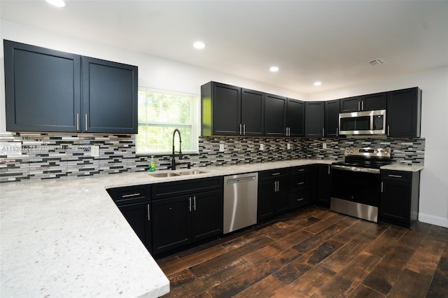 3313 N Ridge Rd, Tallahassee, FL 32305 - kitchen with stainless steel appliances, tasteful backsplash, recessed lighting, dark wood-style flooring, and light stone counters