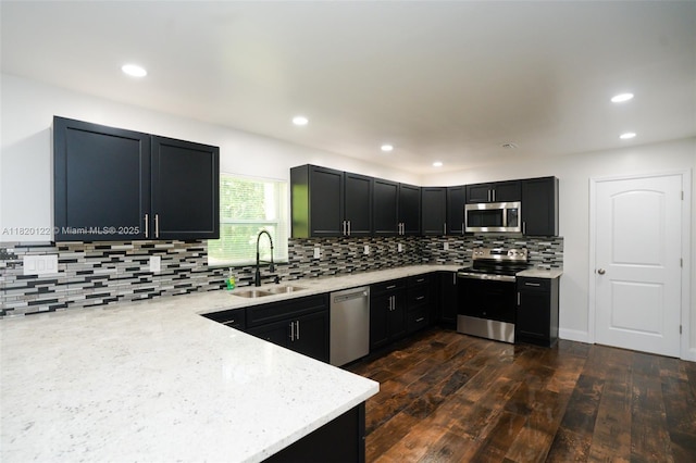 3313 N Ridge Rd, Tallahassee, FL 32305 - kitchen with stainless steel appliances, backsplash, light stone counters, dark cabinetry, and recessed lighting