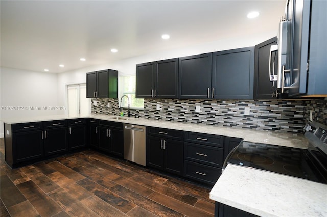 3313 N Ridge Rd, Tallahassee, FL 32305 - kitchen with stainless steel dishwasher, range, a peninsula, decorative backsplash, and recessed lighting