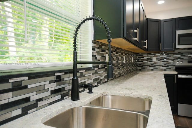 3313 N Ridge Rd, Tallahassee, FL 32305 - kitchen with stainless steel appliances, backsplash, and light stone countertops