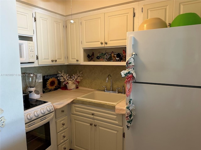 851 Atlantic Shores Blvd Unit 118, Hallandale Beach, FL 33009 - kitchen featuring white appliances, light countertops, decorative backsplash, white cabinets, and open shelves