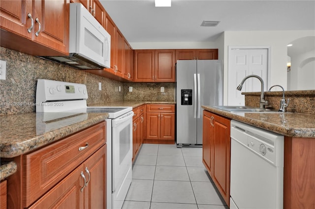 3086 SW 153rd Path, Miami, FL 33185 - kitchen with white appliances, light tile patterned flooring, brown cabinetry, and decorative backsplash