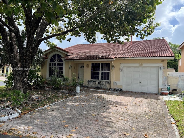 10831 SW 152nd Ct, Miami, FL 33196 - view of front of house with stucco siding, a tiled roof, an attached garage, and decorative driveway