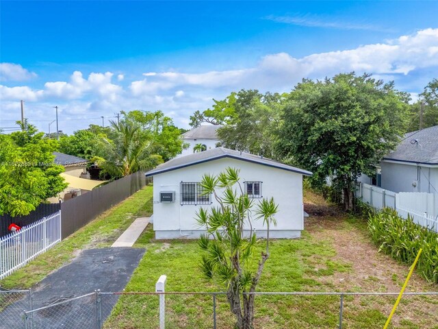 2135 NW 154th St, Miami Gardens, FL 33054 - back of property featuring asphalt driveway and stucco siding