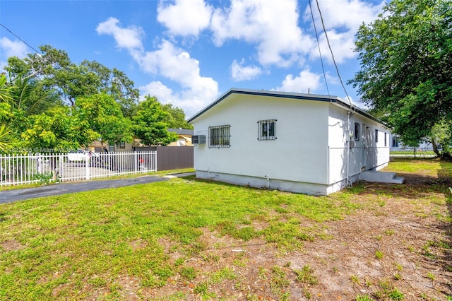 2135 NW 154th St, Miami Gardens, FL 33054 - view of side of home featuring a wall unit AC and stucco siding
