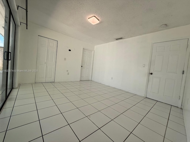 3461 SW 154th Ct, Miami, FL 33185 - unfurnished room with a textured ceiling, a smoke detector, and light tile patterned floors