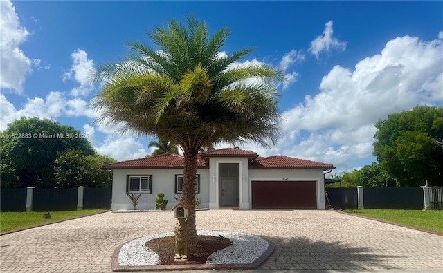 20401 SW 317th St, Homestead, FL 33030 - mediterranean / spanish-style home featuring curved driveway, stucco siding, an attached garage, and a tiled roof