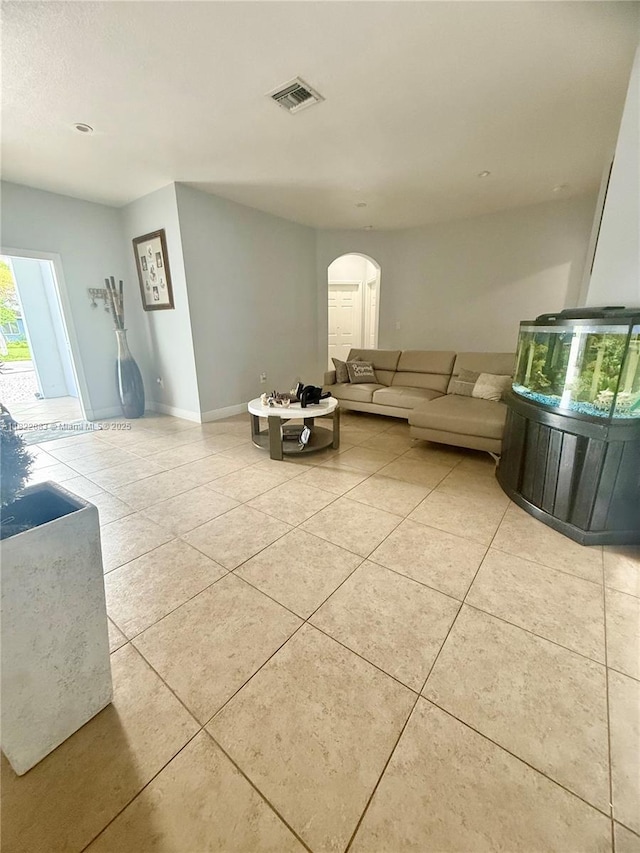20401 SW 317th St, Homestead, FL 33030 - unfurnished living room featuring arched walkways and light tile patterned flooring
