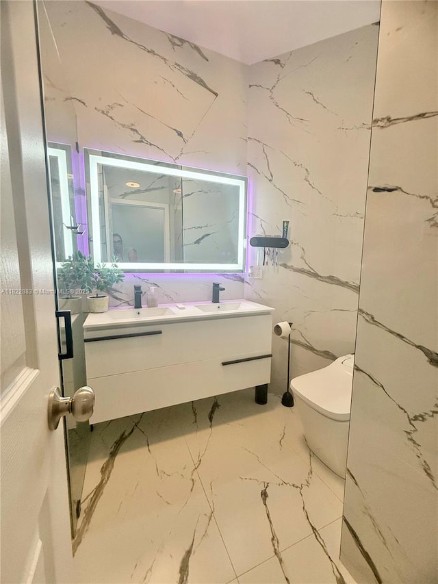 20401 SW 317th St, Homestead, FL 33030 - bathroom featuring marble tiled flooring, double vanity, and stone wall