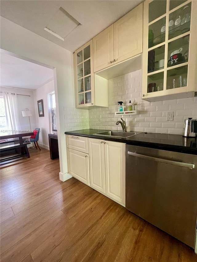 2985 Aviation Ave, Miami, FL 33133 - kitchen with stainless steel dishwasher, dark wood finished floors, healthy amount of natural light, and dark countertops