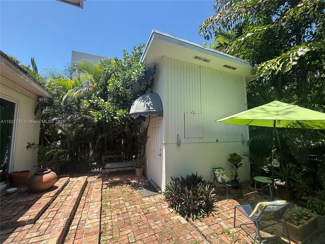 2985 Aviation Ave, Miami, FL 33133 - view of side of home featuring a patio