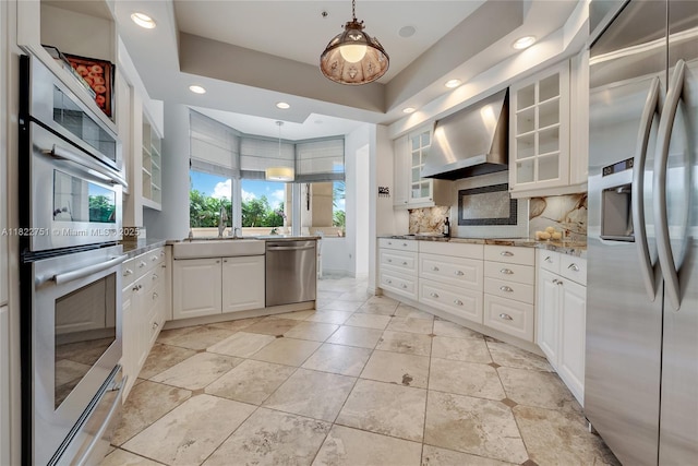 13611 Deering Bay Dr Unit 101, Coral Gables, FL 33158 - kitchen featuring stainless steel appliances, wall chimney range hood, tasteful backsplash, white cabinetry, and recessed lighting