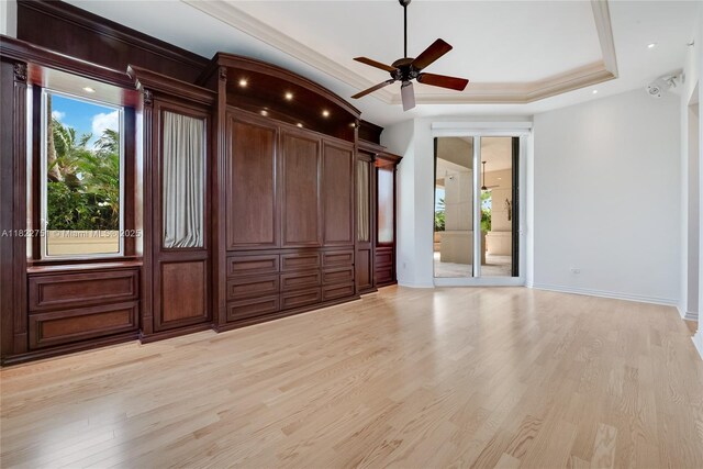 13611 Deering Bay Dr Unit 101, Coral Gables, FL 33158 - unfurnished bedroom with light wood finished floors, a raised ceiling, ornamental molding, access to exterior, and a ceiling fan