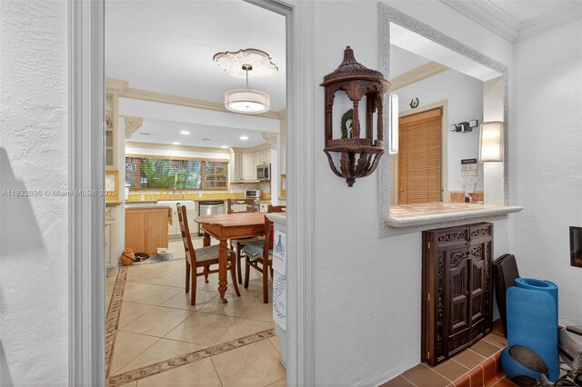 4187 S Le Jeune Rd, Miami, FL 33133 - corridor featuring crown molding, light tile patterned flooring, inlaid floor details, and recessed lighting