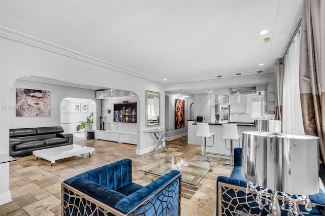 170 NW 105th St, Miami Shores, FL 33150 - living room with arched walkways, stone tile flooring, recessed lighting, and ornamental molding