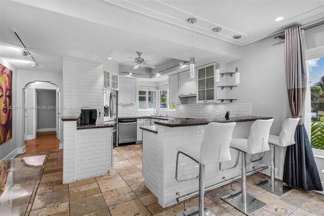 170 NW 105th St, Miami Shores, FL 33150 - kitchen with a peninsula, dishwasher, backsplash, a ceiling fan, and recessed lighting
