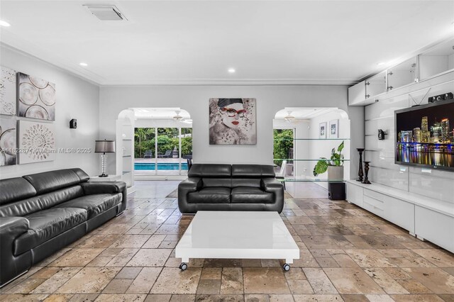 170 NW 105th St, Miami Shores, FL 33150 - living area featuring stone tile flooring, recessed lighting, a ceiling fan, arched walkways, and ornamental molding