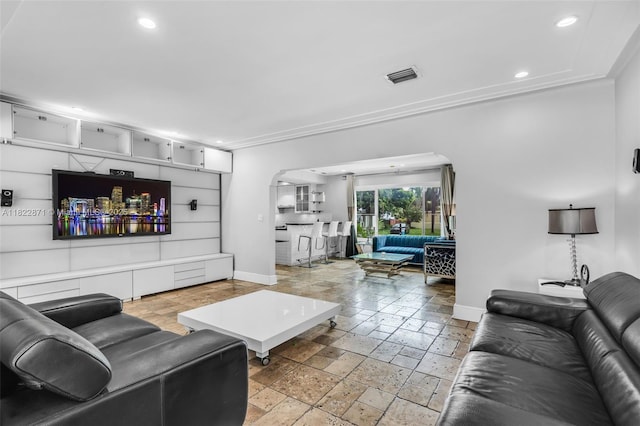 170 NW 105th St, Miami Shores, FL 33150 - living area with arched walkways, stone tile floors, recessed lighting, and ornamental molding