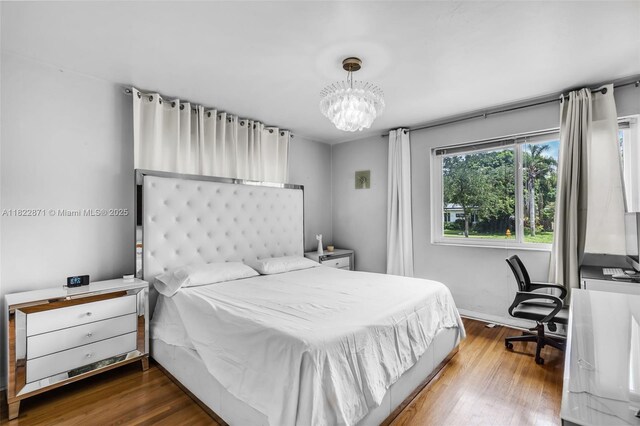 170 NW 105th St, Miami Shores, FL 33150 - bedroom featuring a chandelier and wood finished floors