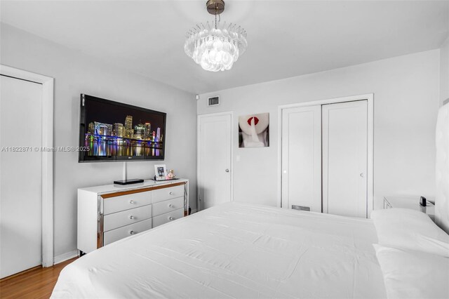 170 NW 105th St, Miami Shores, FL 33150 - bedroom with wood finished floors, a chandelier, and a closet