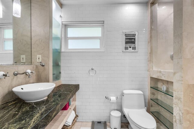 170 NW 105th St, Miami Shores, FL 33150 - bathroom featuring tile walls, heating unit, and vanity