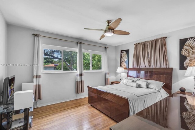 170 NW 105th St, Miami Shores, FL 33150 - bedroom with wood finished floors and a ceiling fan