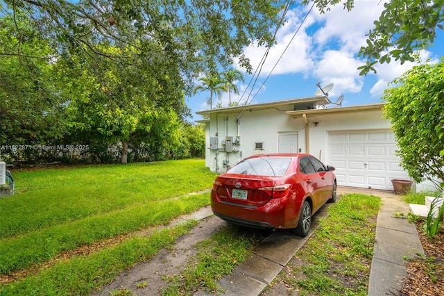 170 NW 105th St, Miami Shores, FL 33150 - view of side of property with a yard, stucco siding, and a garage