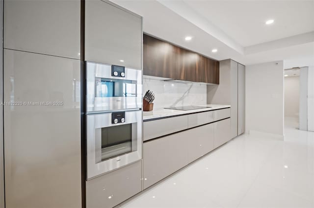 10205 Collins Ave Unit 1504, Bal Harbour, FL 33154 - kitchen with modern cabinets, white refrigerator, recessed lighting, black electric cooktop, and light tile patterned flooring