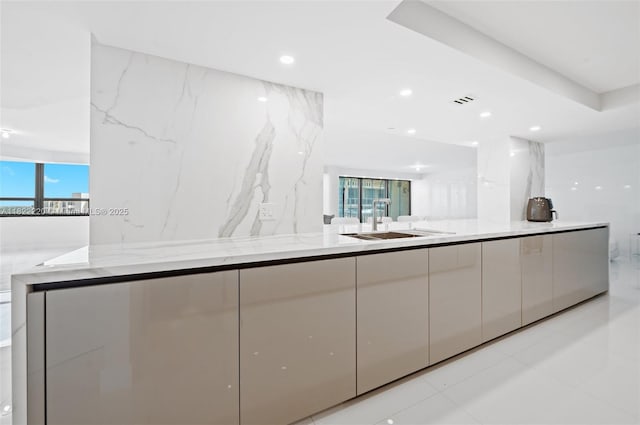10205 Collins Ave Unit 1504, Bal Harbour, FL 33154 - kitchen with modern cabinets, healthy amount of natural light, light stone countertops, white cabinets, and recessed lighting